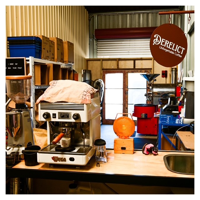 Interior workspace and branding at Derelict Coffee Roasters