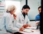 Healthcare professionals discussing practice finances and workload pressures in a New Zealand general practice