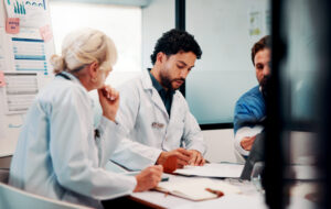Healthcare professionals discussing practice finances and workload pressures in a New Zealand general practice
