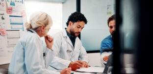 Healthcare professionals discussing practice finances and workload pressures in a New Zealand general practice