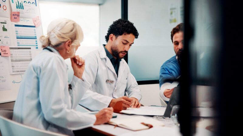 Healthcare professionals discussing practice finances and workload pressures in a New Zealand general practice