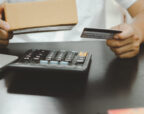 Business owner holding a supplier gift card received through a trade loyalty programme