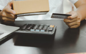 Business owner holding a supplier gift card received through a trade loyalty programme