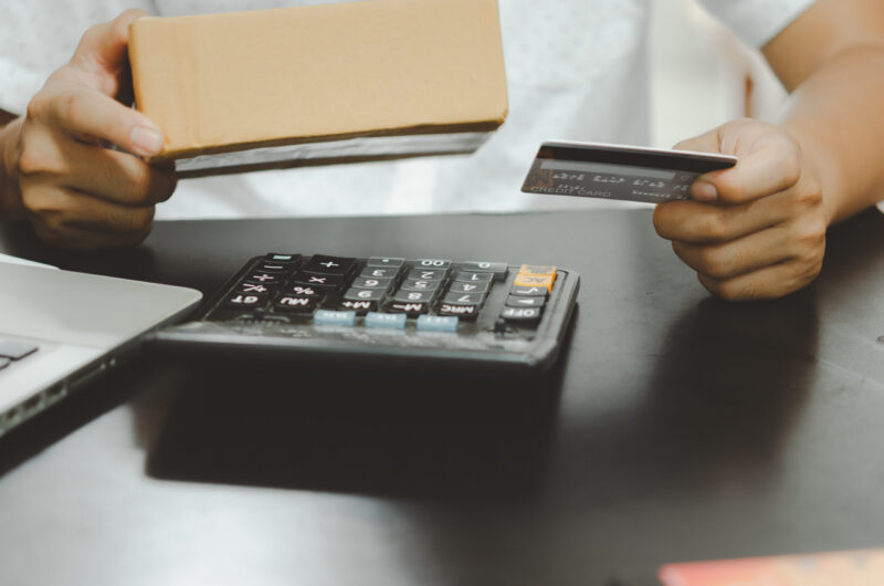 Business owner holding a supplier gift card received through a trade loyalty programme